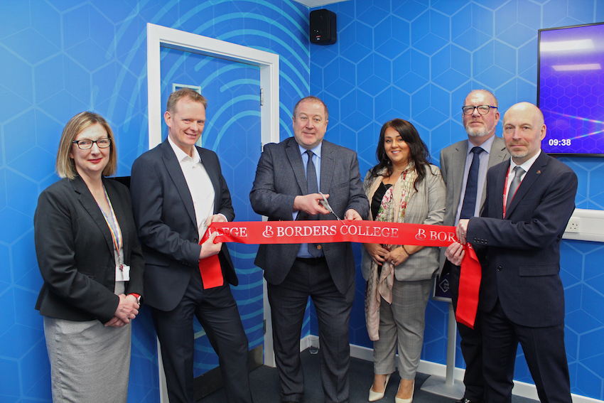 Group of people cutting a ribbon