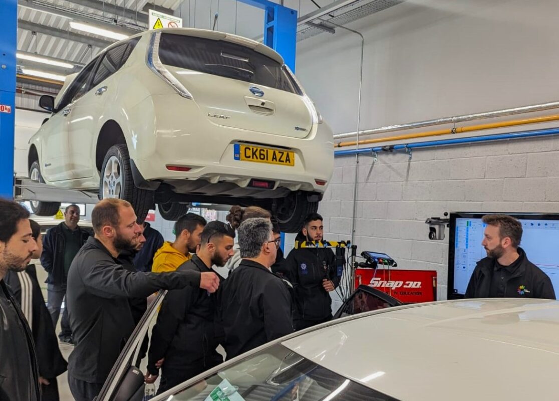 students looking at car