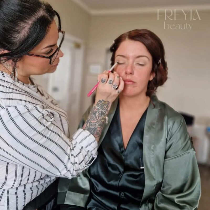 Emma Needham applying make up to a client