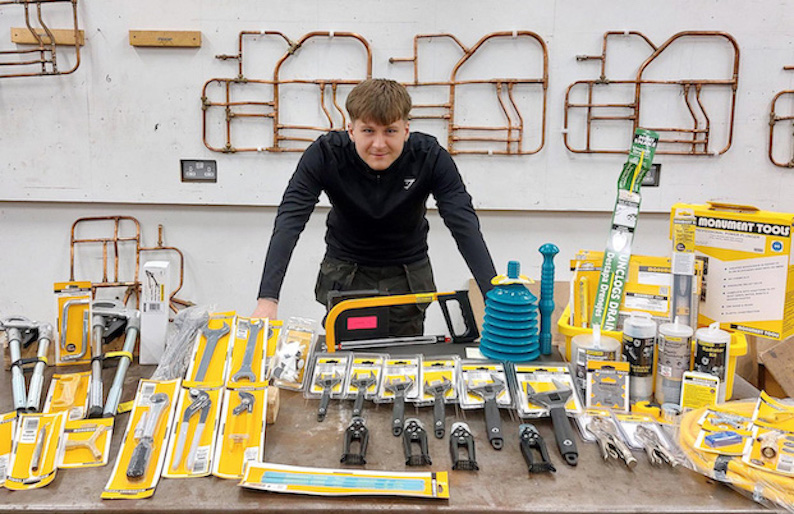 Person standing at workbench with tools