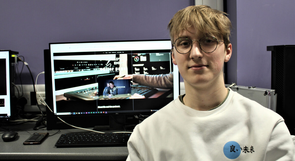 Adam Kane pictured in front of a computer screen.