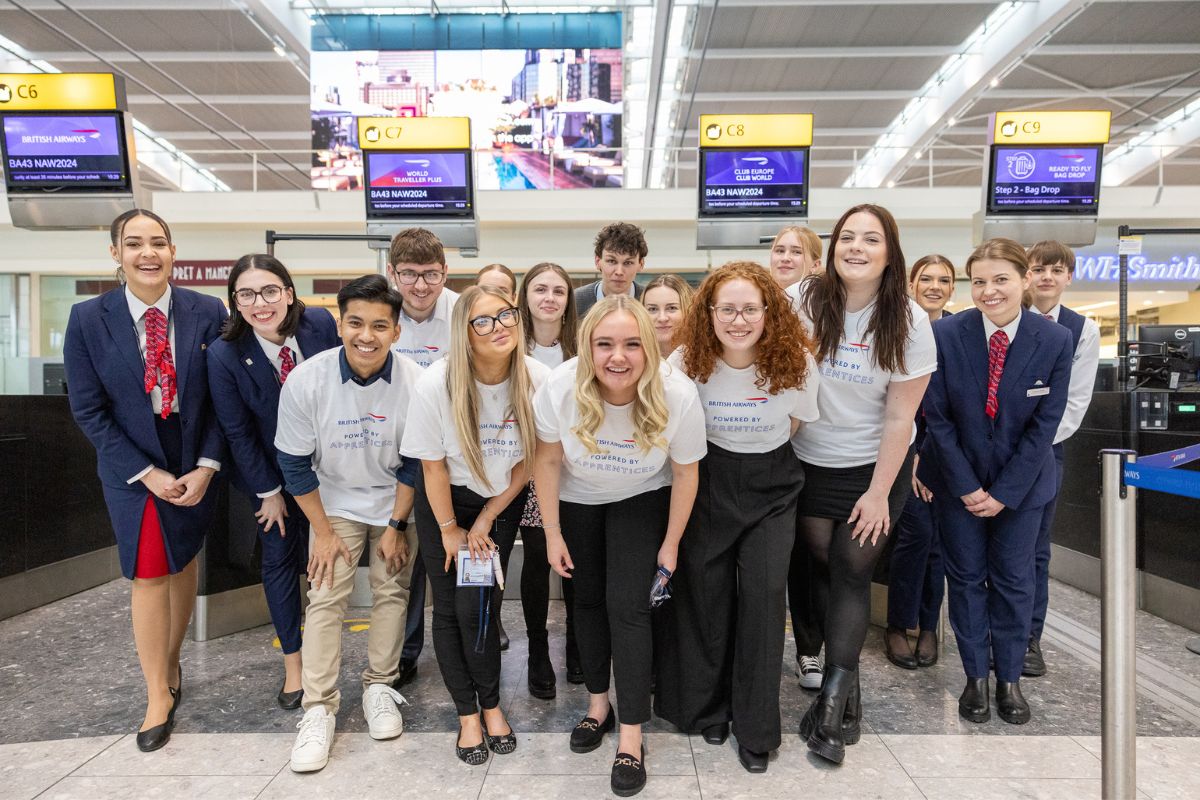 young people posing for photo together in airport