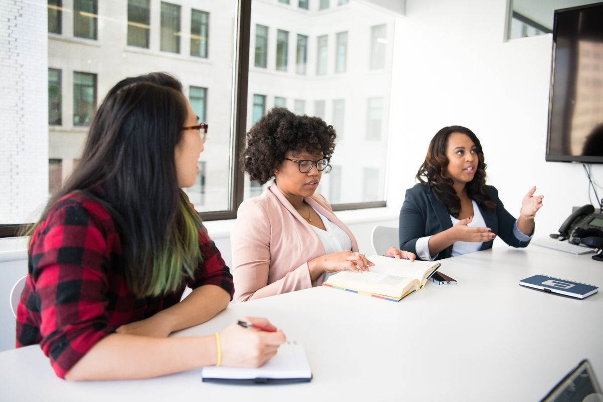 3 ladies running an interview in an office