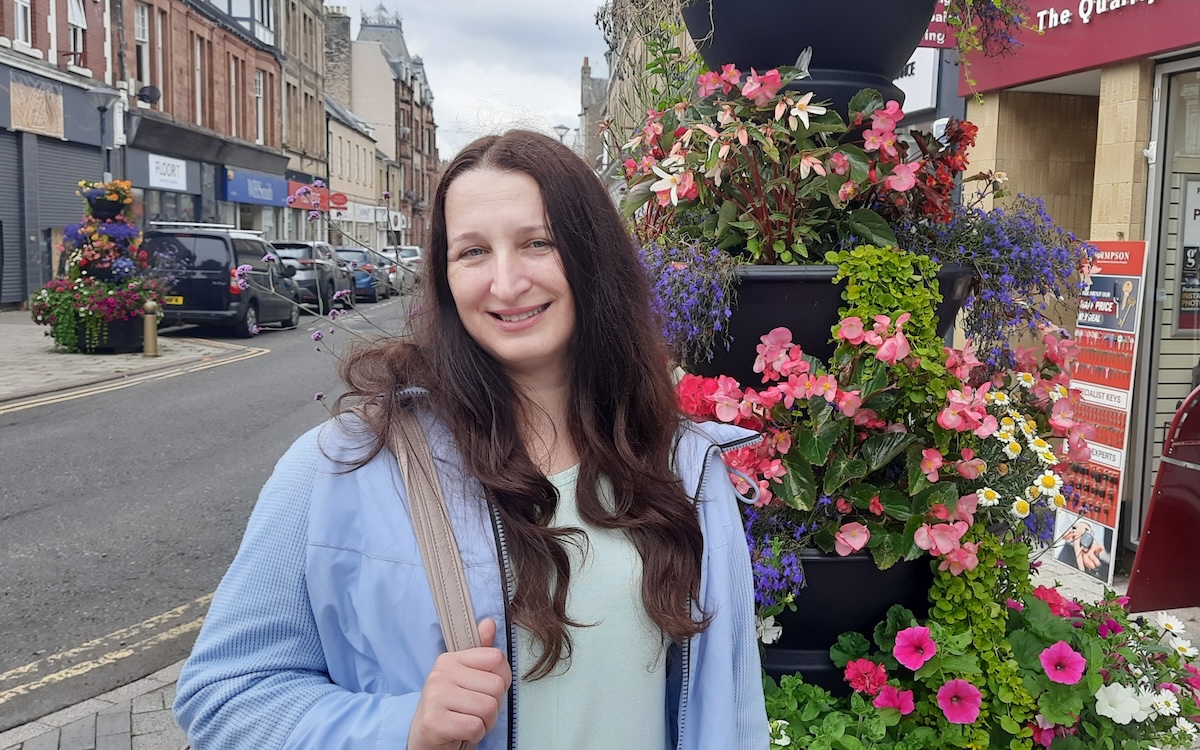 Photo of Svitlana standing outside a shop