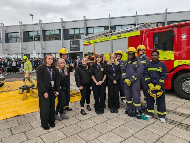 students stood in front of a fire engine