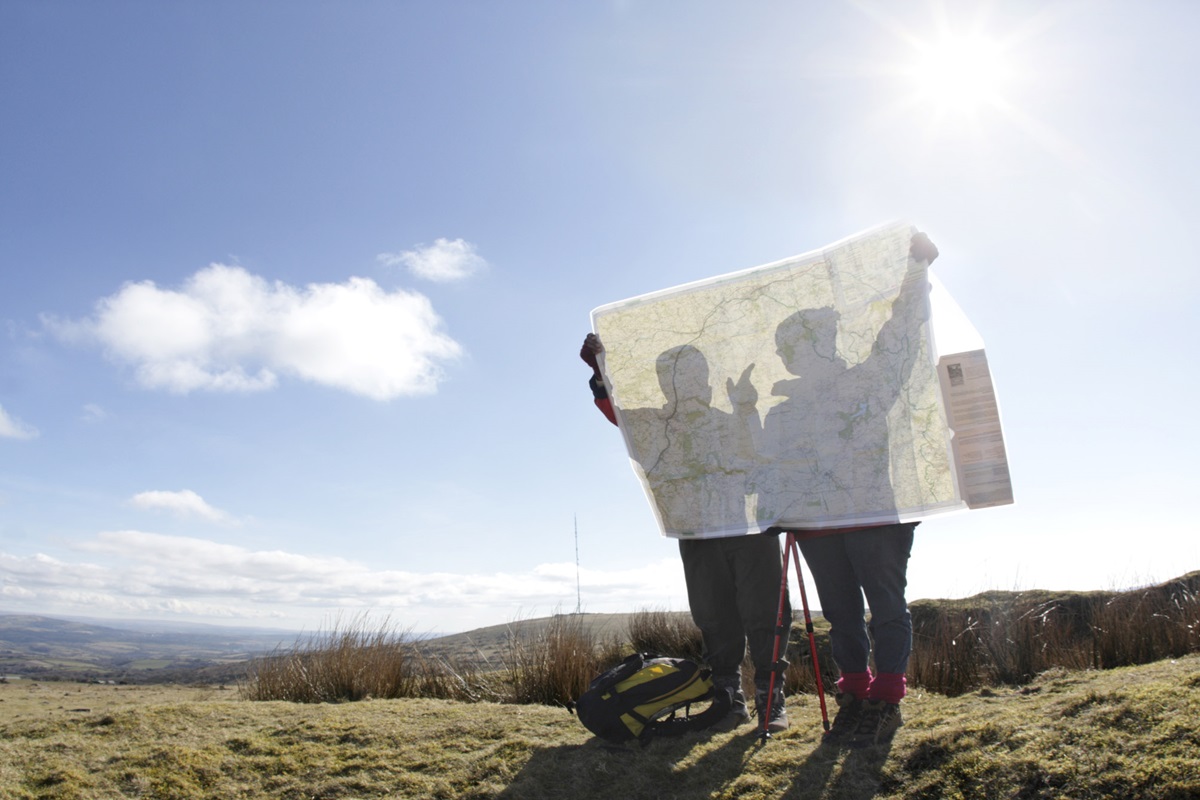 two hikers looking at map