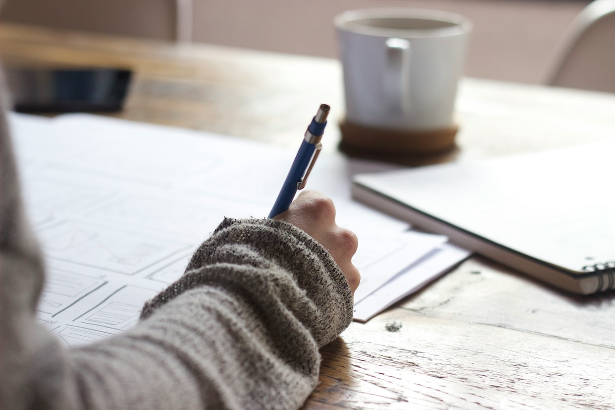 Student working at a desk, unseen unsplash Archetype Coursera