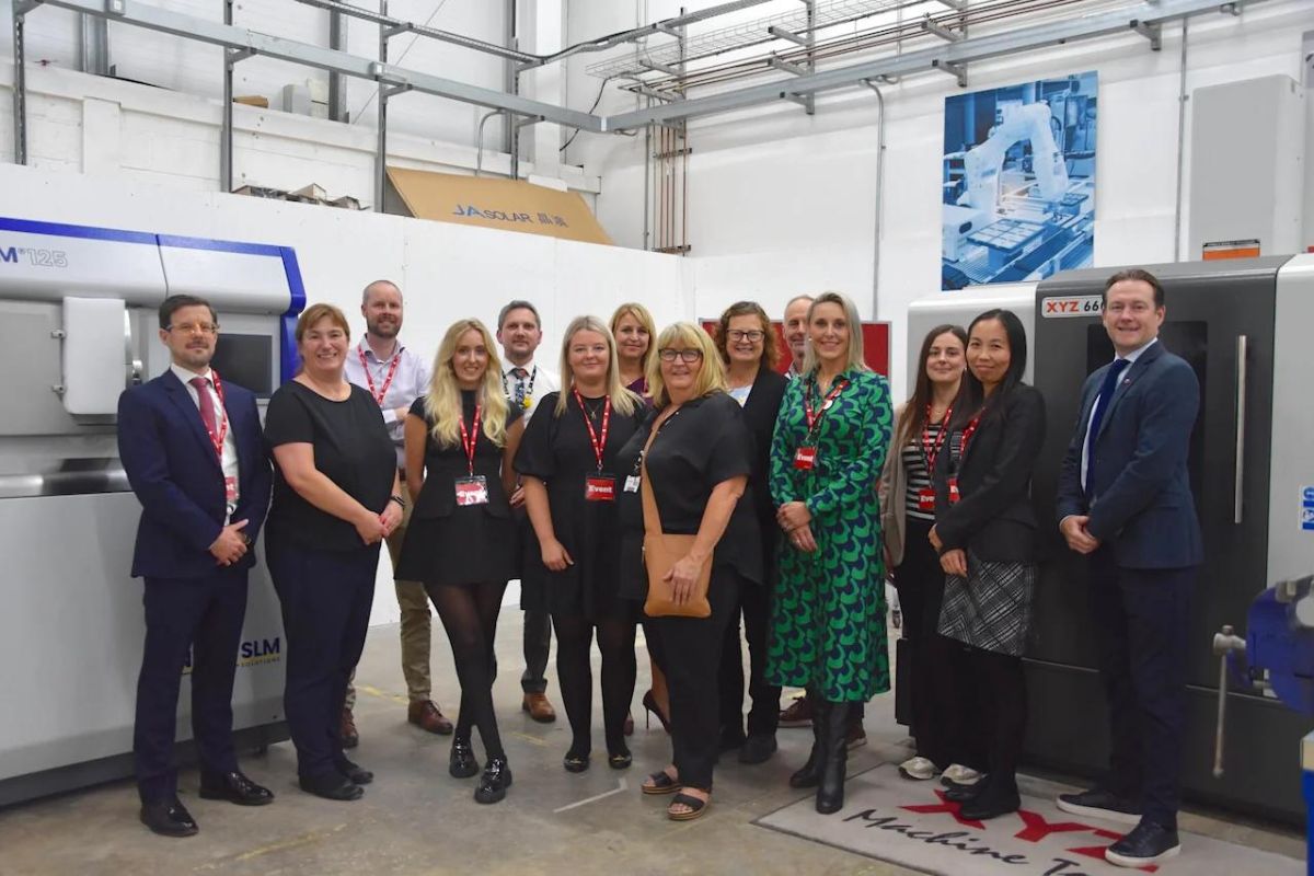 Invited group of business guests at the Bradford Manufacturing Weeks launch event post together in the Bradford College’s Engineering Department workshop.