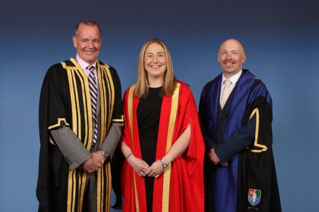 Photograph of 3 people wearing official graduation robes