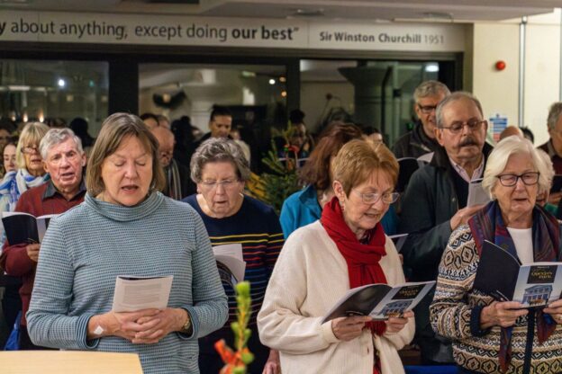 People singing during the Christmas carols service.