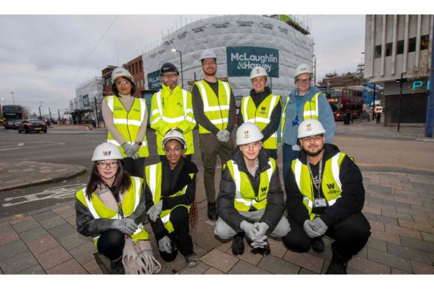 Representatives from City of Wolverhampton College and City of Wolverhampton Council, wearing hi-vis jackers and hard hats. on the site f the new college campus.