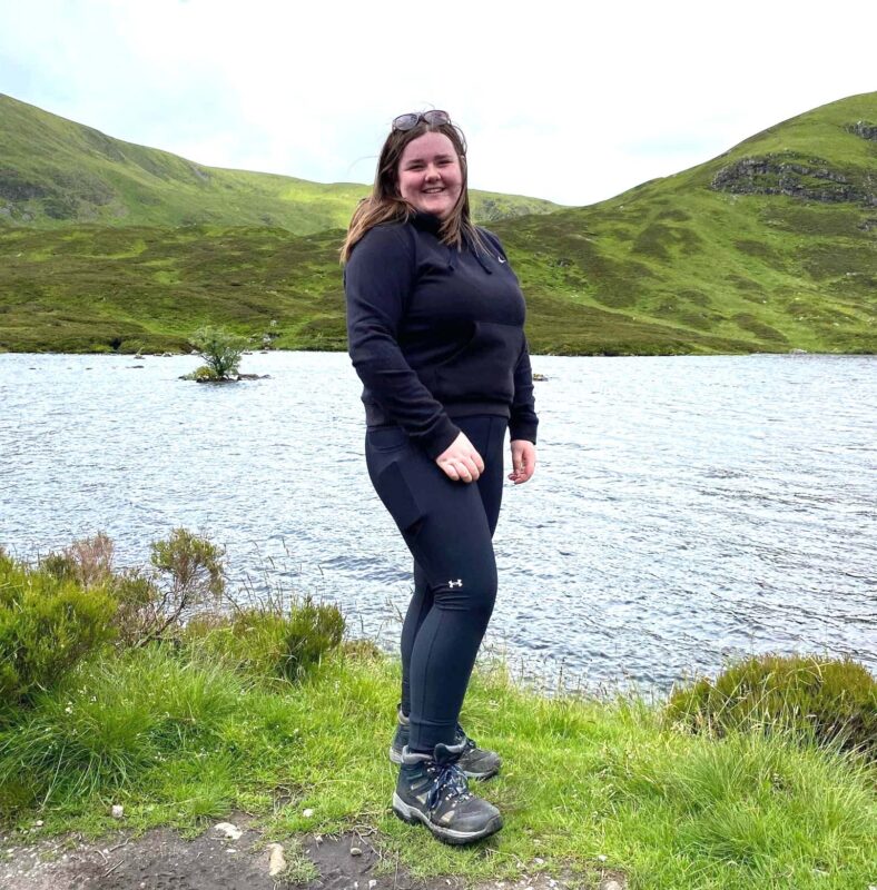 Picture of a woman standing next to a lake