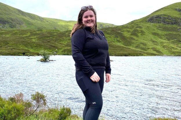 Picture of a woman standing next to a lake