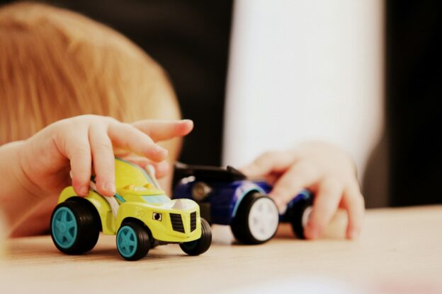 Young child playing with cars