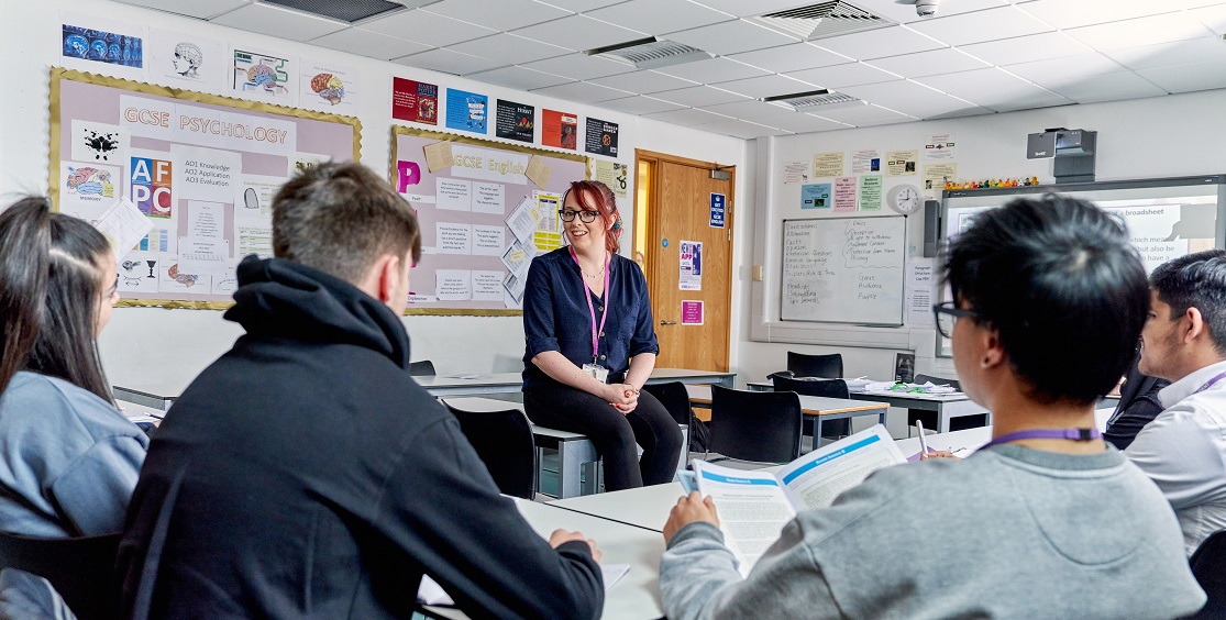 Learners in a South and City College classroom listen to a female tutor