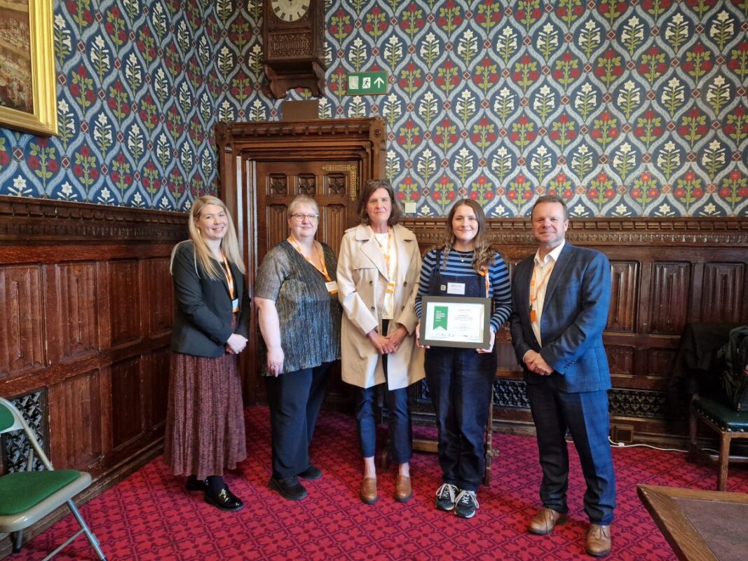 Elizabeth receiving her Keith Fletcher award in Parliament with her tutor and AIM's Access to HE team, and CEO