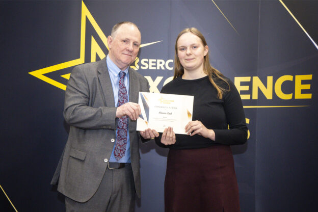 Man presenting certificate to female student