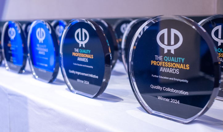 A table with a row of circular glass trophies.